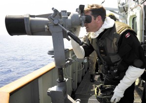 CDR Craig Skjerpen, commanding officer of HMCS Charlottetown, uses the "Big Eyes" binoculars to look for small boats crewed by Libyan pro-regime forces.