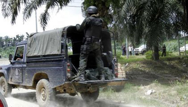 The bodies of Malaysian police commandos killed in the firefight on Friday are loaded into a truck. 