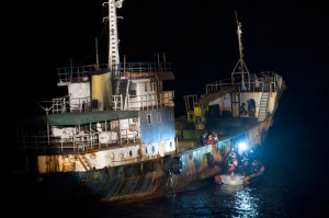 AMLEP in action: A joint U.S. and Sierra Leone law enforcement boarding team talk with the crew of a cargo ship.