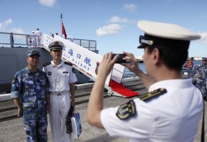 Chinese sailors take a picture together in front of guided missile destroyer Haikou (171) 