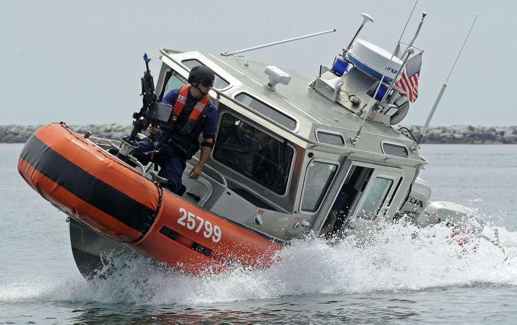 Boat crewmen with Maritime Safety and Security Team Los Angeles - Long Beach conduct tactical boat maneuvers during an exercise, July 31, 2012. The exercise was designed to test the unit's ability to protect a ship docked at a pier as well as underway, using four Coast Guard small boats.
