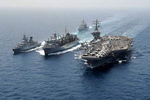 The German navy frigate FGS Hamburg (F220), left, and the aircraft carrier USS Dwight D. Eisenhower (CVN 69), right, take on fuel and stores from the Military Sealift Command fast combat support ship USNS Bridge (T-AOE 10), center, during a replenishment-at-sea in the Arabian Sea on March 23, 2013. The Eisenhower, Hamburg and USS Hue City (CG 66), top, are deployed to the 5th Fleet area of responsibility to conduct maritime security operations and theater security cooperation efforts. 