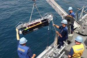 USN sailors load a SeaFox MCM UUV (U.S. Navy photo by Lt. Colby Drake/Released)