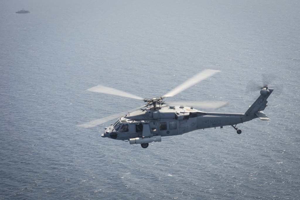An MH-60S equipped with the Airborne Laser Mine Detection System (ALMDS) flies near Bahrain during the ALMDS' maiden deployment. The ALMDS will play a crucial role in quickly detecting moored minefields before friendly vessels enter an area, but the helicopter will require protection. U.S. Navy Photo. 