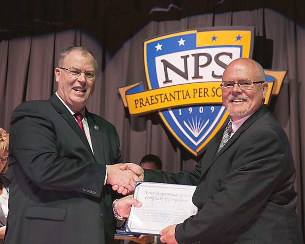 Deputy Secretary of Defense presents a Master of Science diploma to Ken Thomas at the Naval Postgraduate School.