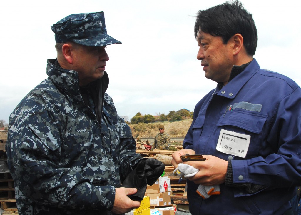 Rear Adm. Jeffrey S. Jones, director of Coalition Naval Advisory and Training Team, speaks with a resident of Oshima, to discuss the progress of disaster relief operations. Marines and sailors assigned to the 31st Marine Expeditionary Unit are on Oshima Island to help clear a harbor and assist with cleaning debris from roads and a local school in support of Operation Tomodachi.Petty Officer 3rd Class Eva Mari.