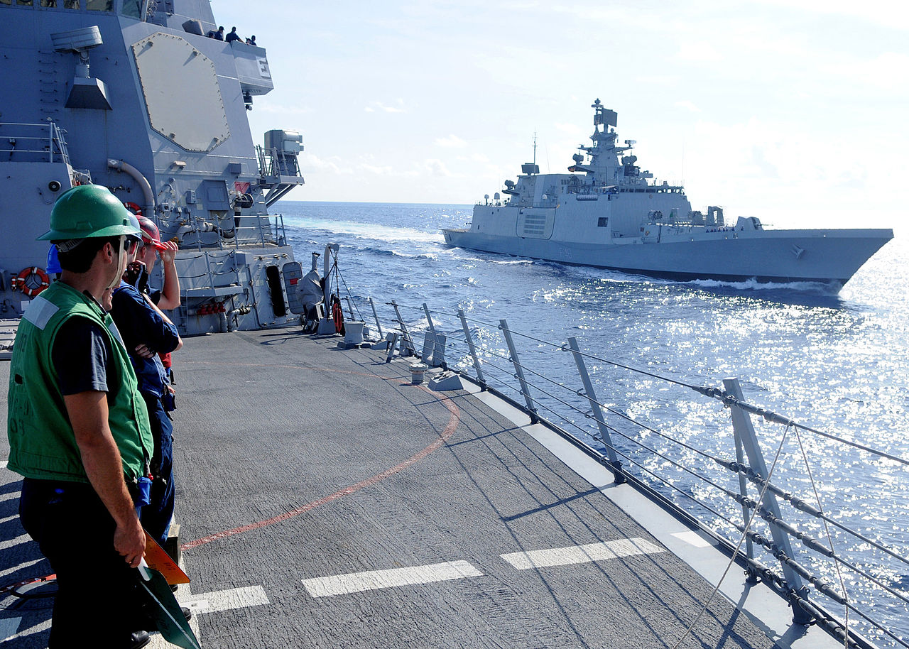 Sailors assigned to the guided-missile destroyer USS Halsey (DDG 97) stand in ranks as the Indian navy destroyer Sapura (F-48) pulls alongside Halsey during a Malabar 2012 exercise.