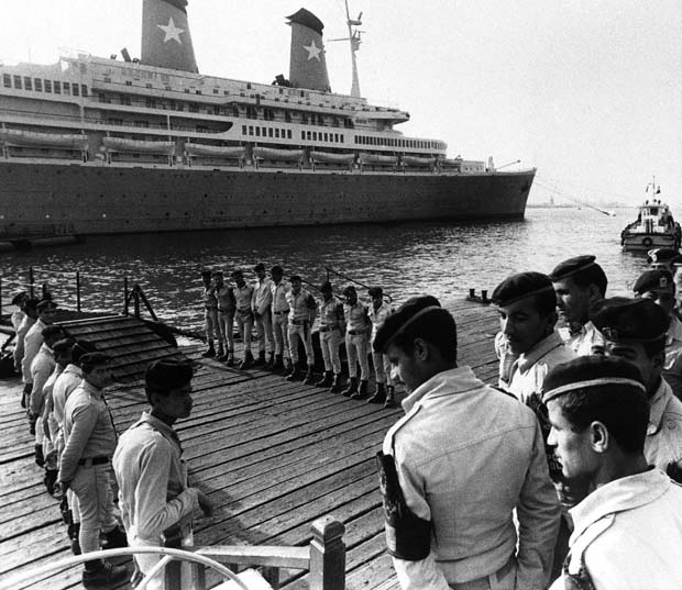 Egyptian central security police guarding the gangplank on which diplomats and others go to and from the Italian cruise liner ?Achille Lauro? which arrived, Thursday, Oct. 10, 1985 in Port Said in this port after being hijacked by four Palestinian for more than 48-hours. The four hijackers has left Egypt after they surrendered go to the Egyptian authorities on Wednesday. (AP Photo)