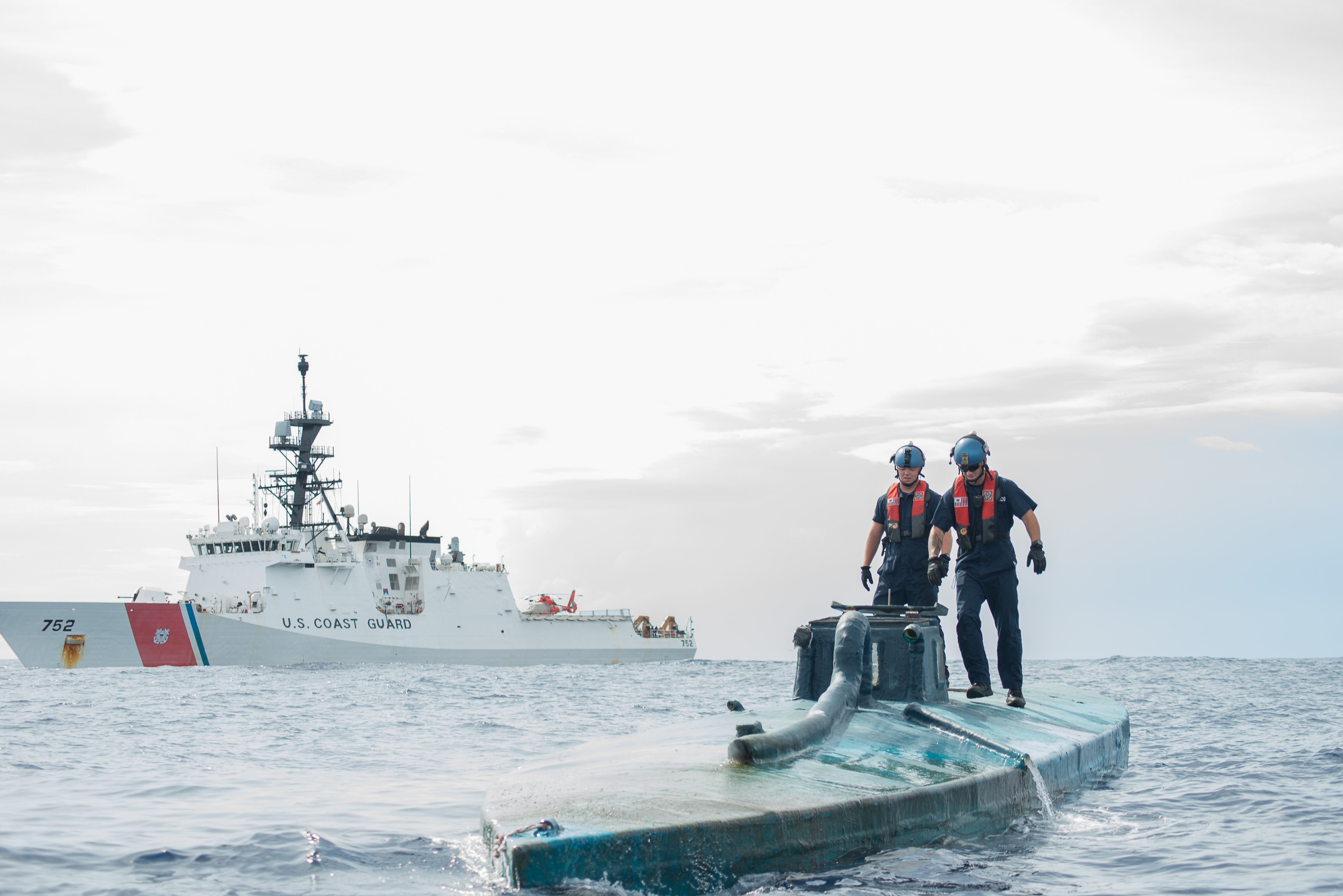 A Coast Guard Cutter Stratton boarding team investigates a self-propelled semi-submersible interdicted in international waters off the coast of Central America, July 19, 2015. The Stratton’s crew recovered more than 6 tons of cocaine from the 40-foot vessel. (Coast Guard photo courtesy of Petty Officer 2nd Class LaNola Stone)