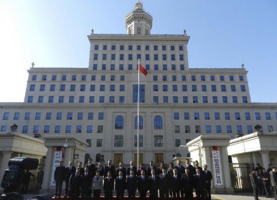 March 22, 2013: Staff members of the newly-merged State General Administration of Press, Publication, Radio, Film and Television pose for group photos during a ceremony to hang the new nameplate in Beijing (Photo Credit: Xinhua/Wang Zhen).