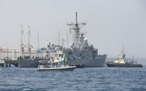 A 34' SeaArk assigned to CRS ONE escorts USS DE WERT (FFG 45) as she gets underway from Djibouti in September 2013. Credit: USAF Photo by SSgt Chad Warren.