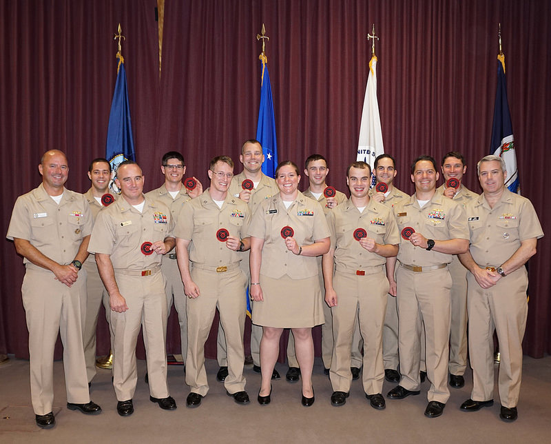 DAHLGREN, Va. (May 27, 2016) Graduates of the rigorous 19 week Integrated Air and Missile Defense (IAMD) Warfare Tactics Instructor (WTI) Course pose for a picture with Rear Adm. James W. Kilby, Commander, Naval Surface and Mine Warfighting Development Center (NSMWDC) (left), and Rear Adm. Ronald A. Boxall, Commander, Carrier Strike Group Three (right) at NSMWDC Detachment Dahlgren. Course graduates serve in a production tour as trainers and instructors at critical training and evaluation commands throughout the Navy and then return to operational Fleet command billets following their normal career progression model. (U.S. Navy photo by Information Management Specialist Laurie Buchanan)