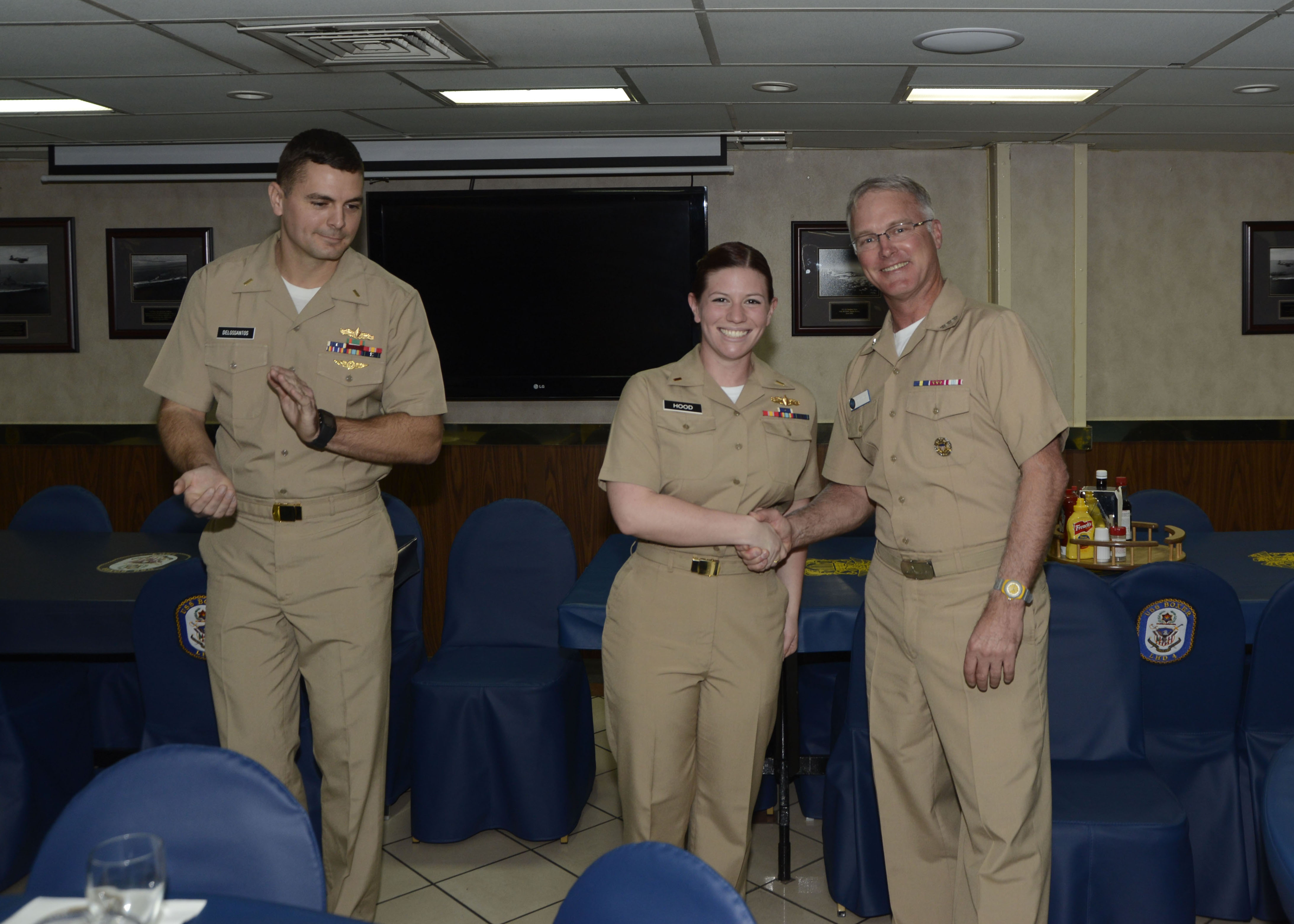 SAN DIEGO (Feb. 9, 2015) - Ens. Lauren Hood, Operations Intelligence Division Officer for the amphibious assault ship USS Boxer (LHD 4) is awarded her Surface Warfare Officer pin by Vice Adm. Thomas S. Rowden, Commander, Naval Surface Forces, in Boxer's wardroom. Boxer is currently undergoing a planned maintenance availability in San Diego. (U.S. Navy photo by Mass Communication Specialist 2nd Class Briana Taylor/Released)