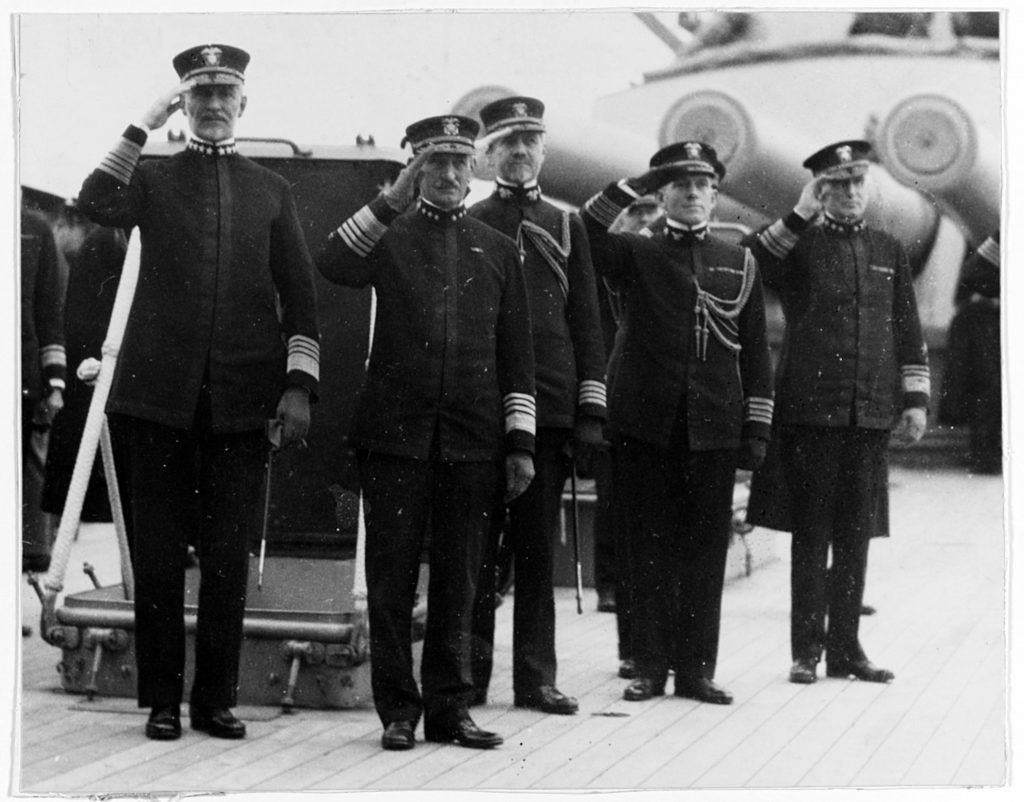 (Previously Unpublished) Commander, U.S. Naval Forces in Europe, Admiral William S. Sims, salutes with the Commander, Atlantic Fleet, Admiral Henry T. Mayo, with their chiefs of staffs on board the flagship of the Atlantic Fleet, USS Pennsylvania (BB-38). After the armistice in November of 1918, Sims and Mayo assumed four star rank. Their close collaboration during the First World War provided the template for headquarters ashore to support future U.S. Navy operations at sea. Together, the staffs serving under Sims and Mayo pioneered contemporary concepts of joint and combined naval command.