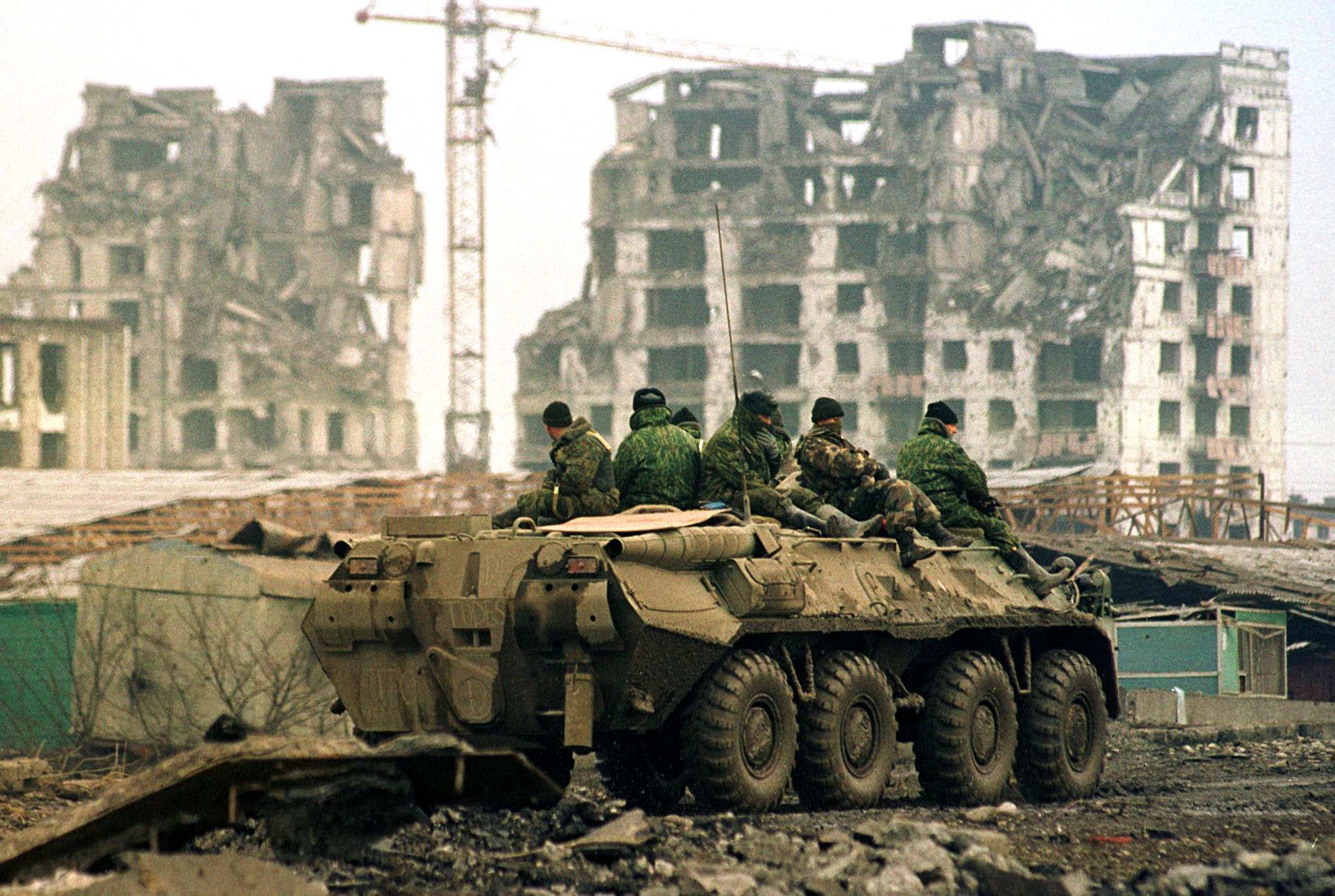 Russian troops on patrol ride atop an armoured vehicle through Grozny February 7. Russian officials flew to Chechnya to visit the shattered regional capital on Tuesday where the military has launched a "clean up"operation to kill those rebels still in hiding. WAW - RTR12QU
