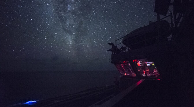 Red lights glow from the primary flight control room aboard the USS Ronald Reagan during a darken ship period. (U.S. Navy photo by Mass Communication Specialist 3rd Class Ryan McFarlane/Released)