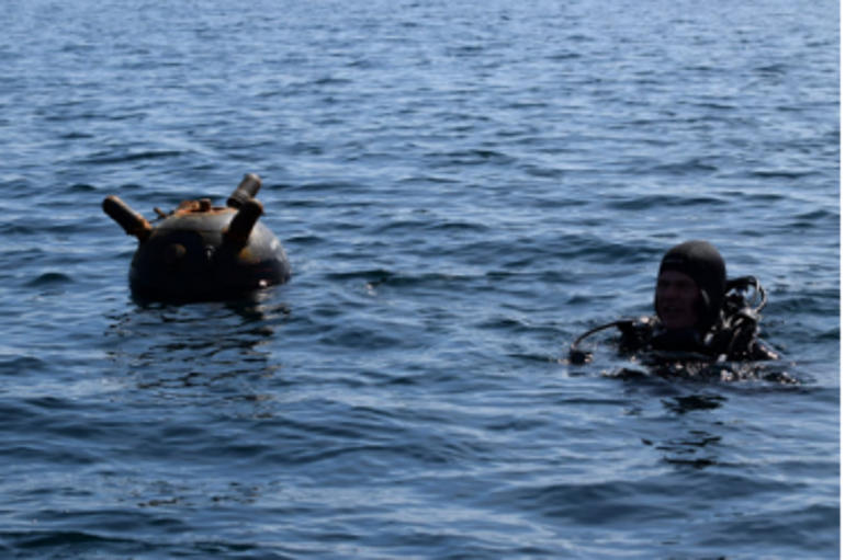 Figure 4. Romanian Navy EOD operator near a drifting Ukrainian mine in the Black Sea (Credit: Ionut Felea - Fortele Navale Romane)